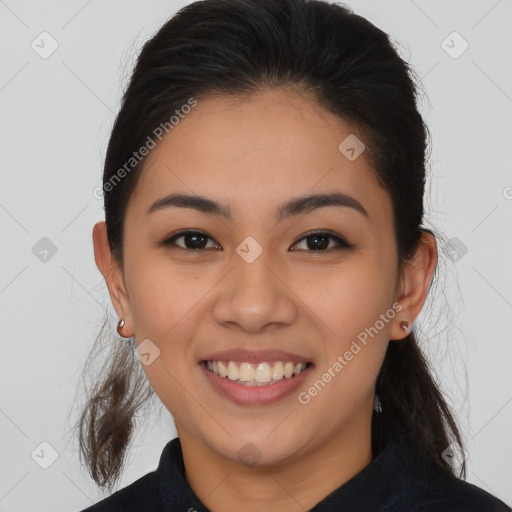 Joyful latino young-adult female with long  brown hair and brown eyes