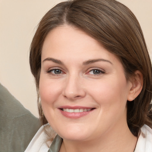 Joyful white young-adult female with medium  brown hair and brown eyes