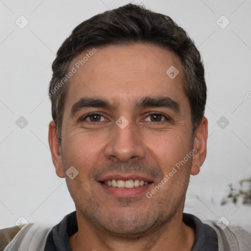 Joyful white young-adult male with short  black hair and brown eyes
