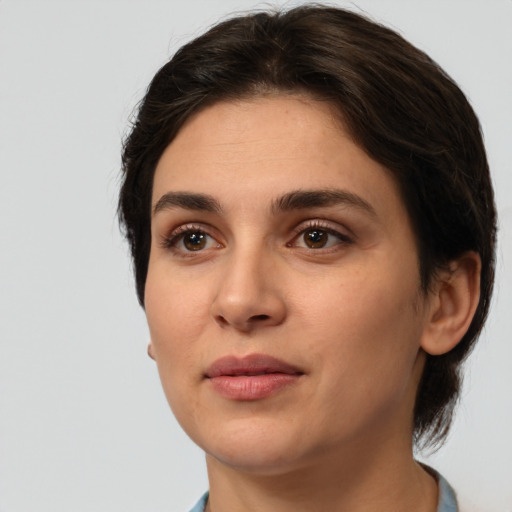 Joyful white young-adult female with medium  brown hair and brown eyes