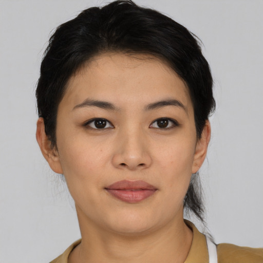 Joyful asian young-adult female with short  black hair and brown eyes