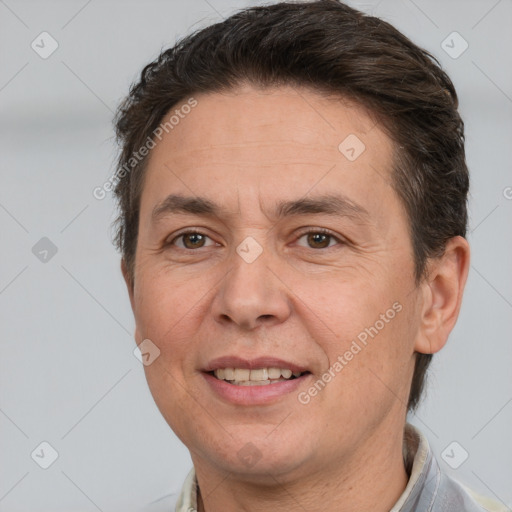 Joyful white adult male with short  brown hair and brown eyes