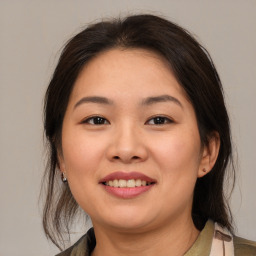 Joyful white young-adult female with medium  brown hair and brown eyes