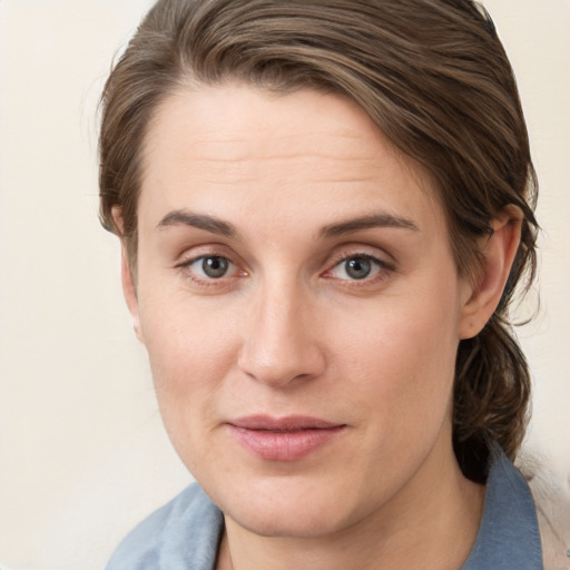 Joyful white young-adult female with medium  brown hair and grey eyes