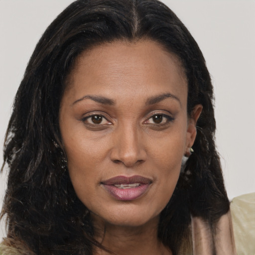 Joyful black adult female with long  brown hair and brown eyes