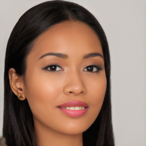 Joyful latino young-adult female with long  brown hair and brown eyes