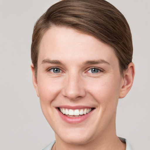 Joyful white young-adult female with short  brown hair and grey eyes