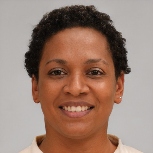 Joyful black young-adult female with short  brown hair and brown eyes