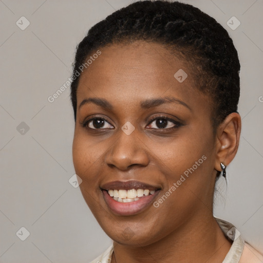 Joyful black young-adult female with short  black hair and brown eyes