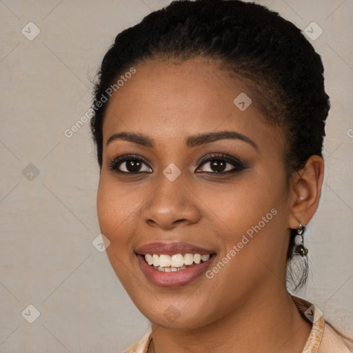 Joyful black young-adult female with long  black hair and brown eyes