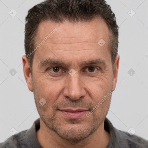 Joyful white adult male with short  brown hair and brown eyes