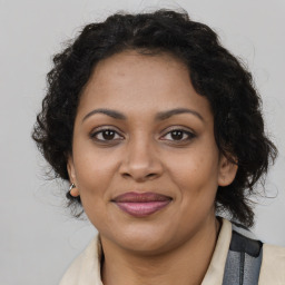 Joyful black young-adult female with medium  brown hair and brown eyes