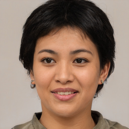 Joyful asian young-adult female with medium  brown hair and brown eyes