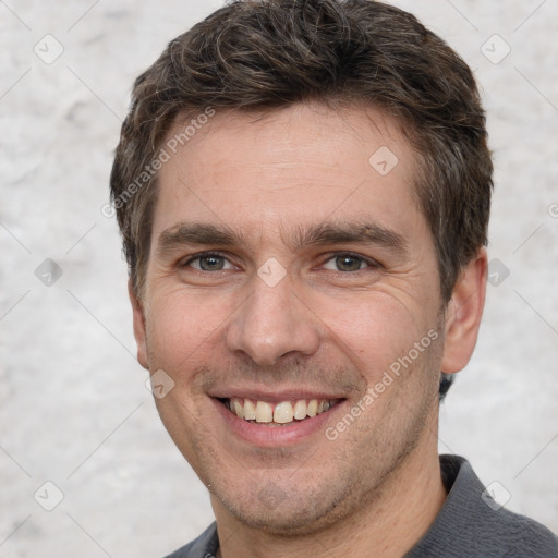 Joyful white adult male with short  brown hair and brown eyes