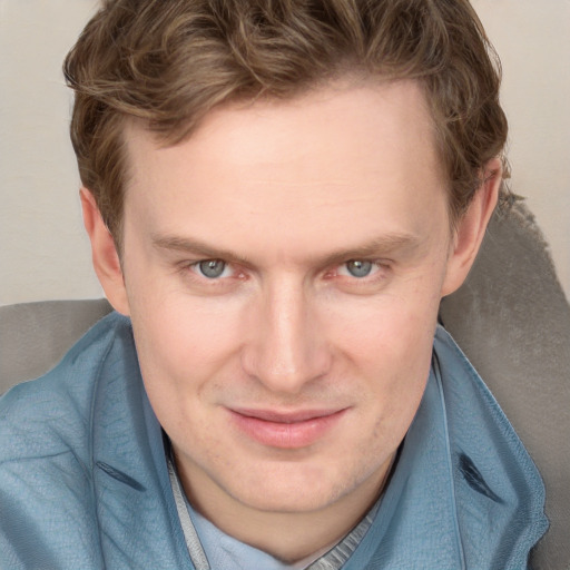 Joyful white adult male with short  brown hair and blue eyes