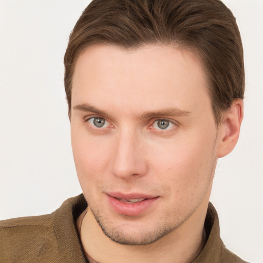 Joyful white young-adult male with short  brown hair and grey eyes