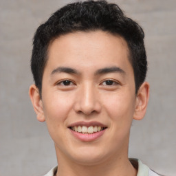 Joyful asian young-adult male with short  brown hair and brown eyes