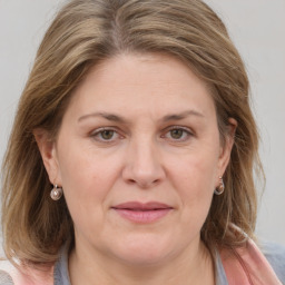 Joyful white adult female with medium  brown hair and grey eyes