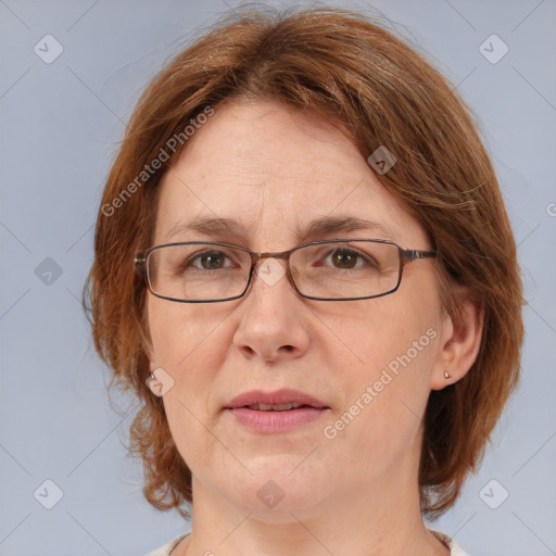 Joyful white adult female with medium  brown hair and blue eyes