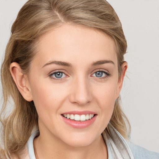 Joyful white young-adult female with medium  brown hair and blue eyes