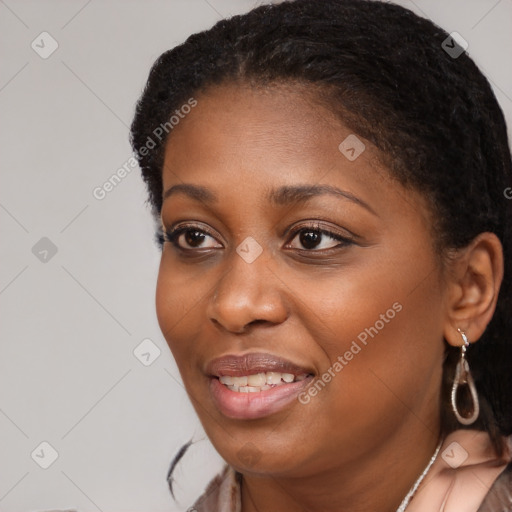 Joyful black young-adult female with long  black hair and brown eyes