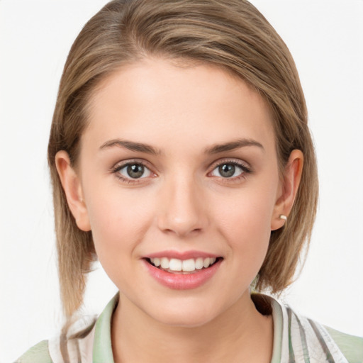 Joyful white young-adult female with medium  brown hair and blue eyes