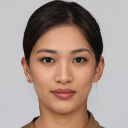 Joyful asian young-adult female with short  brown hair and brown eyes