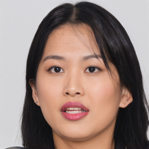Joyful asian young-adult female with long  black hair and brown eyes