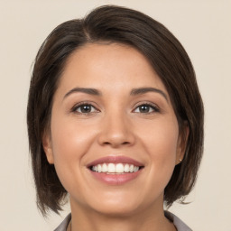 Joyful white young-adult female with medium  brown hair and brown eyes