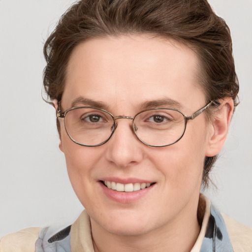 Joyful white adult female with short  brown hair and blue eyes