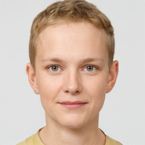 Joyful white young-adult female with short  brown hair and grey eyes