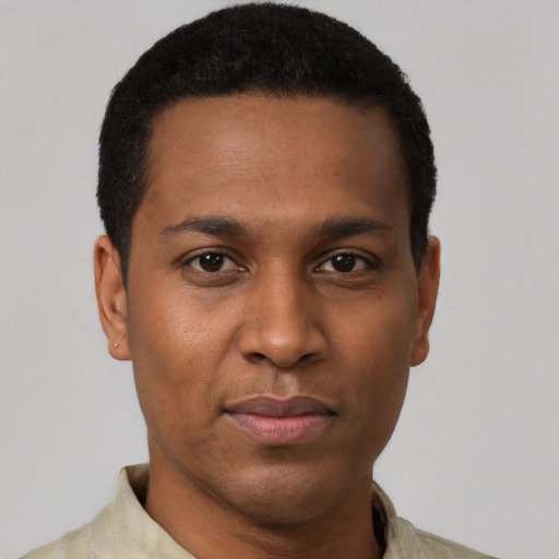 Joyful black young-adult male with short  black hair and brown eyes