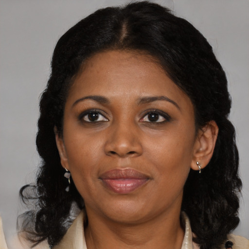 Joyful black adult female with medium  brown hair and brown eyes