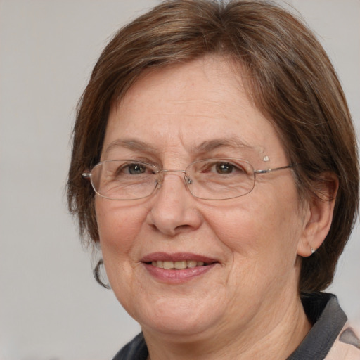 Joyful white middle-aged female with medium  brown hair and brown eyes