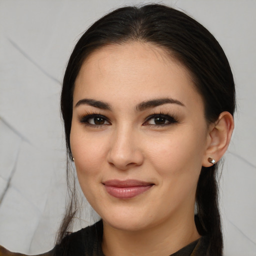 Joyful white young-adult female with long  black hair and brown eyes