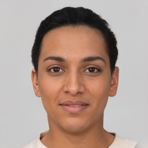 Joyful latino young-adult female with short  black hair and brown eyes