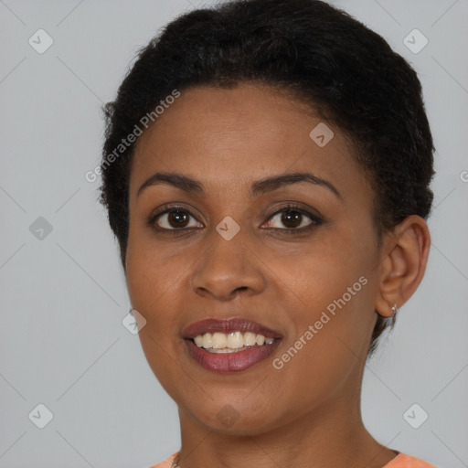 Joyful black young-adult female with short  brown hair and brown eyes