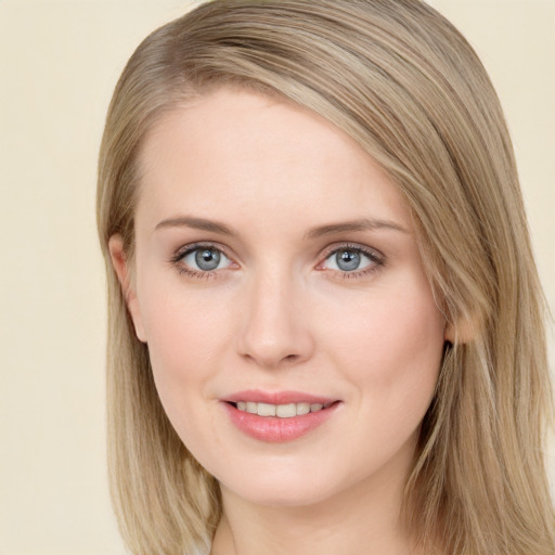 Joyful white young-adult female with long  brown hair and blue eyes