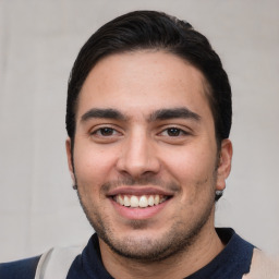 Joyful white young-adult male with short  black hair and brown eyes