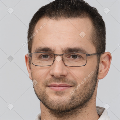 Joyful white adult male with short  brown hair and brown eyes