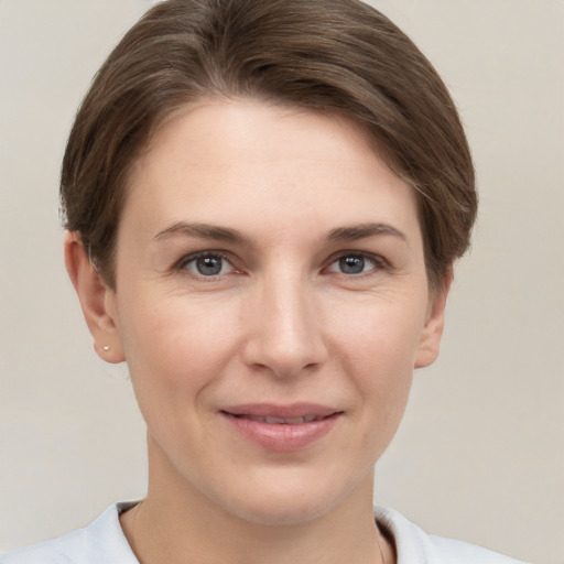 Joyful white young-adult female with short  brown hair and grey eyes