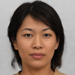 Neutral asian young-adult female with medium  brown hair and brown eyes