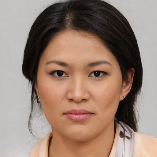 Joyful asian young-adult female with medium  brown hair and brown eyes