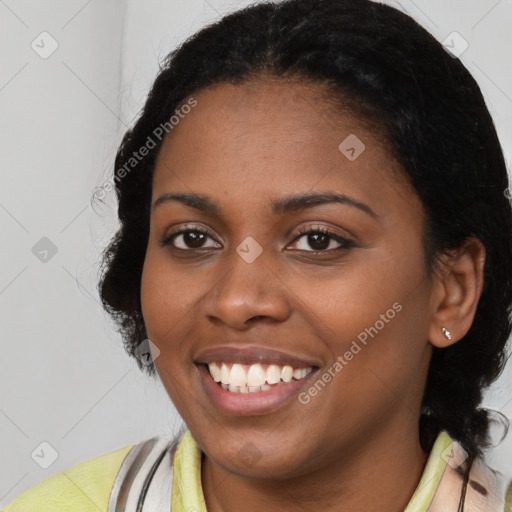 Joyful black young-adult female with long  brown hair and brown eyes