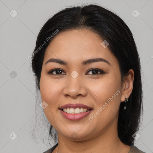 Joyful latino young-adult female with long  brown hair and brown eyes