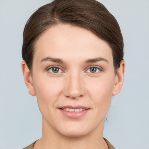 Joyful white young-adult female with short  brown hair and grey eyes