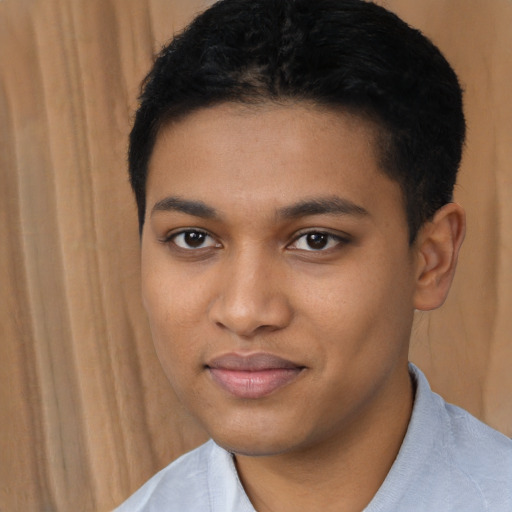 Joyful black young-adult male with short  brown hair and brown eyes