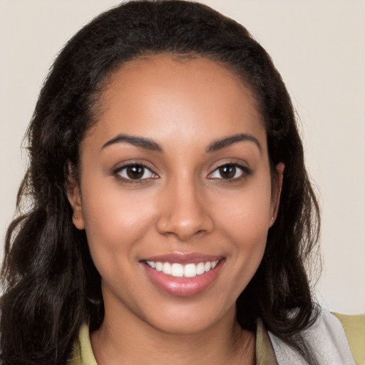 Joyful latino young-adult female with long  brown hair and brown eyes