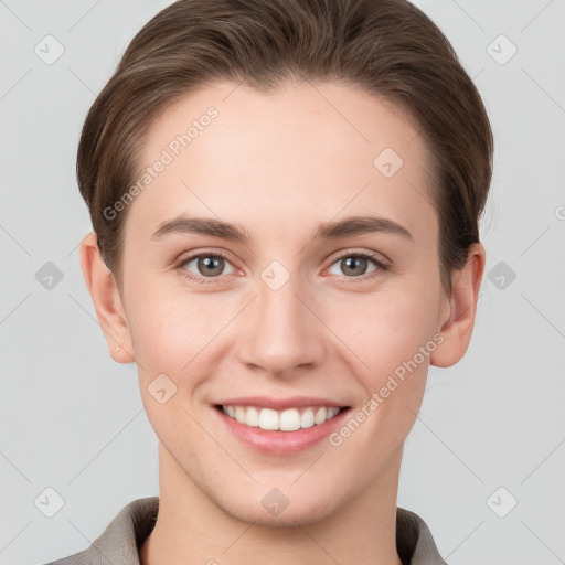 Joyful white young-adult female with short  brown hair and grey eyes