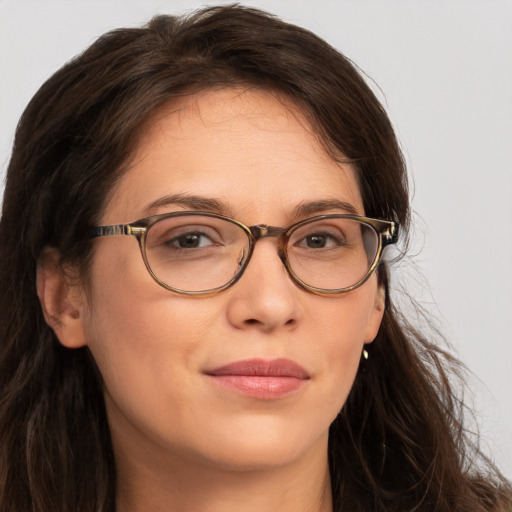 Joyful white adult female with long  brown hair and brown eyes